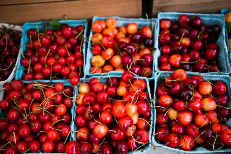 Seasonal produce - fresh cherries in packages for the farmers market in May