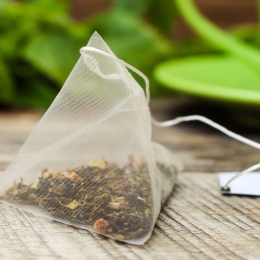tea leaves in a plastic pyramid-shaped tea bag