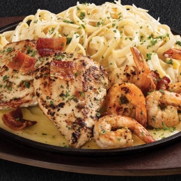 plate of chicken, shrimp, and pasta with melted cheese