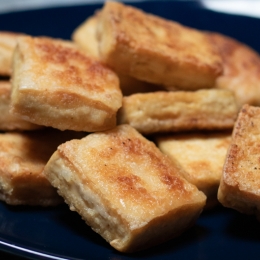 black pan with crispy tofu pieces 