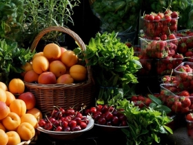 Fresh apricots, peaches, cherries and strawberries for sale at a farmer's market in May