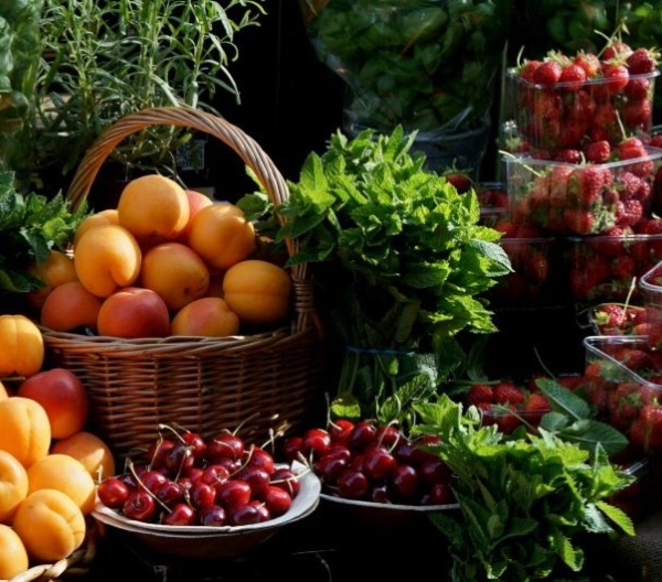Fresh apricots, peaches, cherries and strawberries for sale at a farmer's market in May