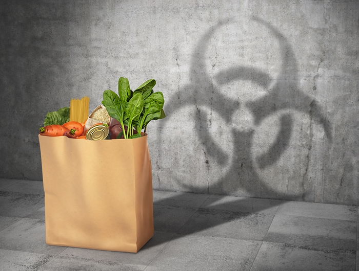 grocery bag casting a shadow of a hazardous chemical symbol