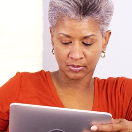 a woman reading news on her tablet