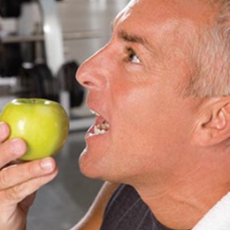 man biting into apple