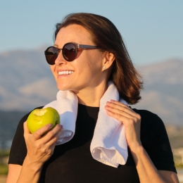 a woman holding an apple