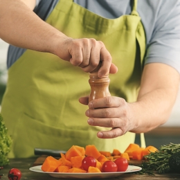 a man seasoning vegetables