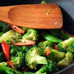broccoli, peppers, snap peas in bowl with wooden spoon