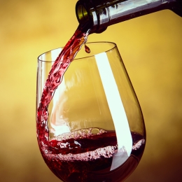 red wine pouring into a glass