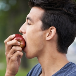 person biting an apple
