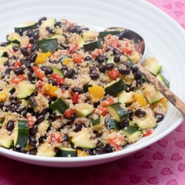 white bowl filled with black bean and quinoa and other vegetables