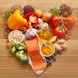 vegetables laid in a heart shape on wood background