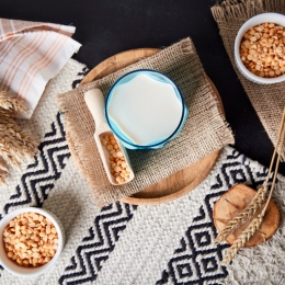 grains and bowl of milk laid on burlap