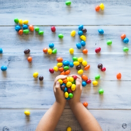 Child's hands overflowing with M&Ms