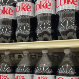 gricery store selves filled with 2 liter bottles of diet coke