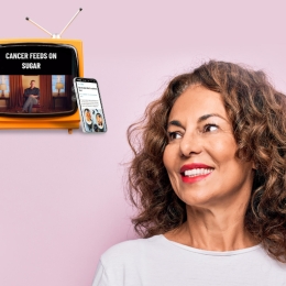pink background with woman looking towards a tv and phone with diet ads on them