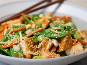 a bowl of ginger sesame tofu with snow peas
