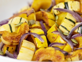 sliced delicata squash roasted and topped with sliced onions