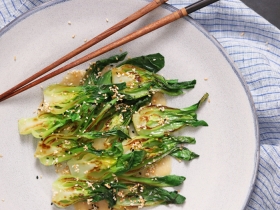 cooked bok choy with sesame sauce drizzled on top