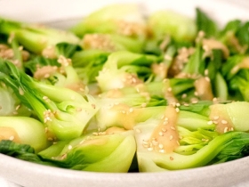 steamed bok choy with sesame sauce drizzled on top