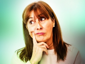woman in a thinking position on blurred green background