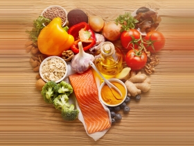 vegetables laid in a heart shape on wood background