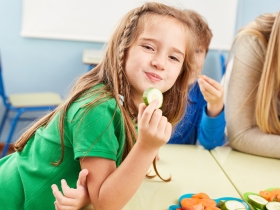 a girl enjoying a healthy snack at school