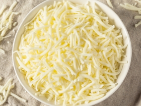 white bowl filled with light shredded cheese