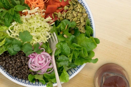 bowl of salad with dressing on side