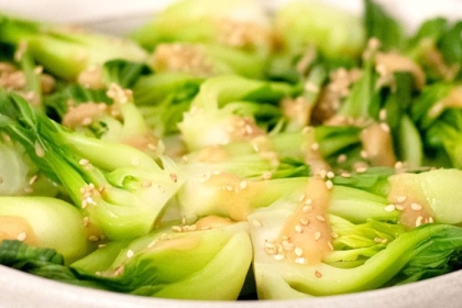 steamed bok choy with sesame sauce drizzled on top