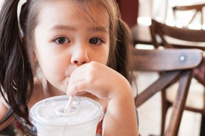 Child drinks soda from straw