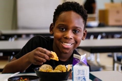 A boy eating school lunch