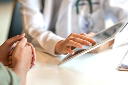doctor and patient looking at a tablet