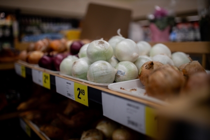 Assorted onions on display in a supermarket