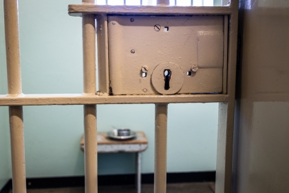 Prison cell with an empty plate and bowl on a table