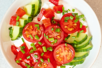bowl filled with tomatoes, cucumbers and cottage cheese