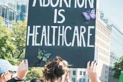 Protester carries sign reading "Abortion is Healthcare"