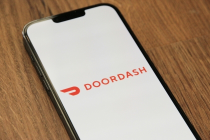 A mobile phone displaying the DoorDash loading screen