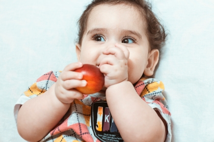 Toddler eating a nectarine