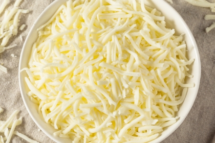 white bowl filled with light shredded cheese