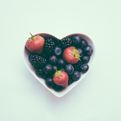 Heart shaped bowl with blueberries and strawberries