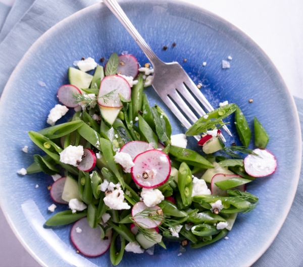 sliced radishes and snap peas topped with feta cheese