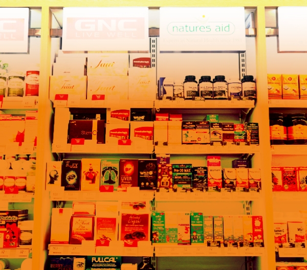 image of supplements on store shelves with an orange hue