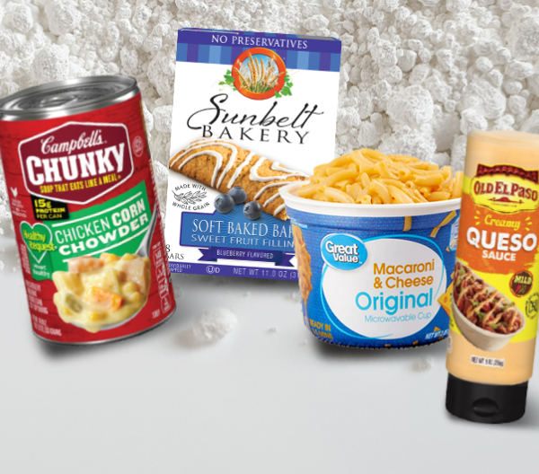 Canned soup, boxed mac & cheese, breakfast bars, and queso--packaged foods containing titanium dioxide--against a background of the powdered white substance.