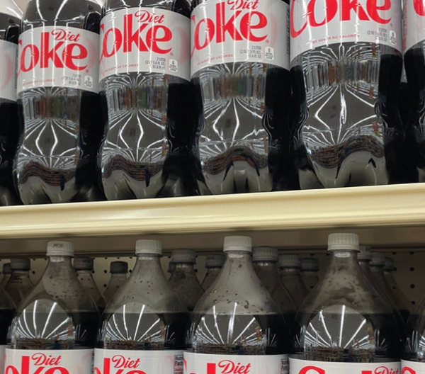 gricery store selves filled with 2 liter bottles of diet coke