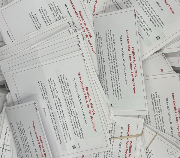 A pile of paper mailers from supporters of CSPI's petition to ban Red 3, addressed to FDA Commissioner Robert Califf