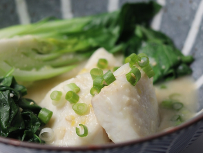 white fish place in a broth with bok choy