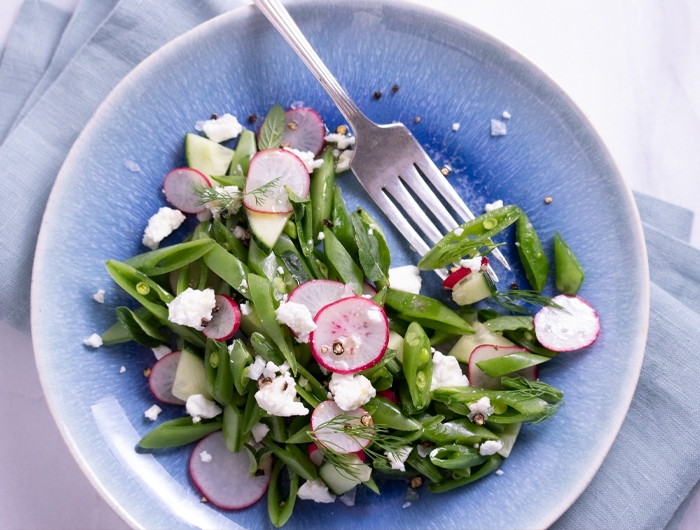 sliced radishes and snap peas topped with feta cheese