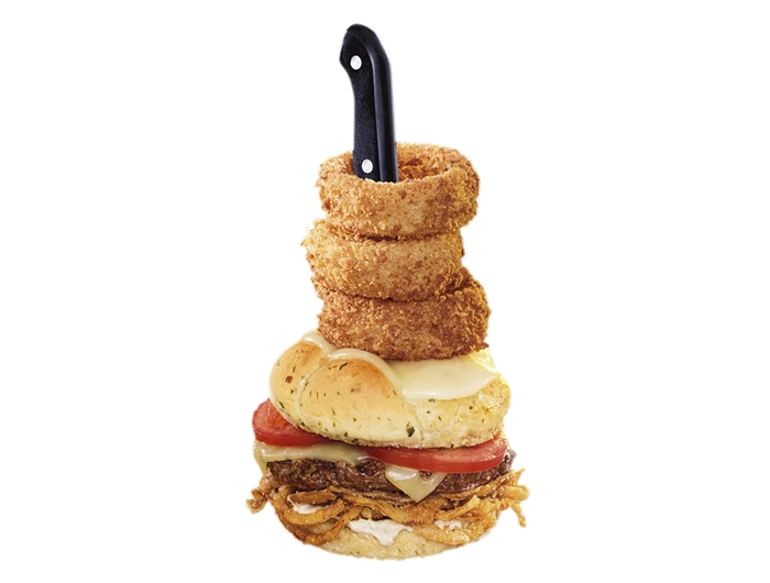 burger with onion rings stacked on top
