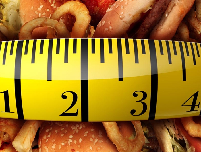 tape measure stretched across junk food